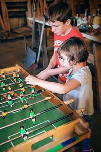 High angle view of boys playing foosball