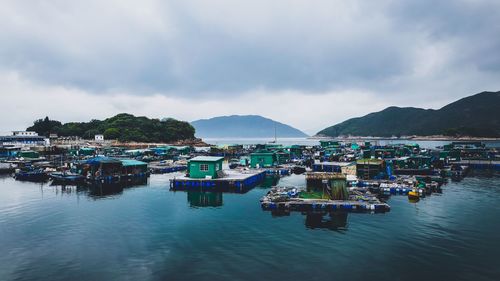 Houses floating on sea against sky