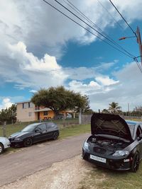 Cars on road against sky