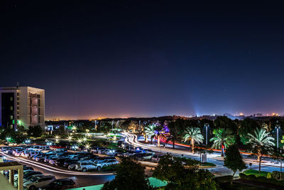 Illuminated swimming pool against sky at night
