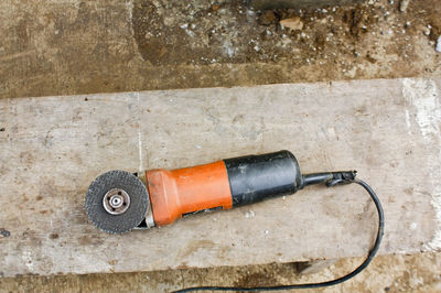 High angle view of polishing machine on wooden plank