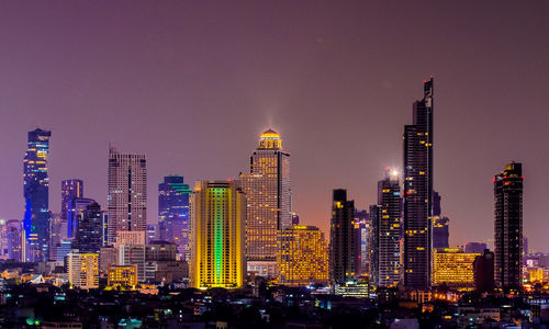 View of skyscrapers lit up at night