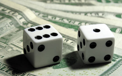 Close-up of dice on paper currency