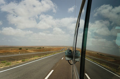 Vehicle on road against sky