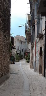 Empty alley amidst buildings in city