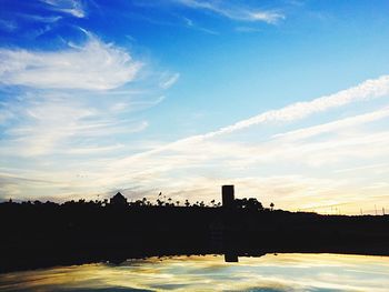 Scenic view of river against cloudy sky