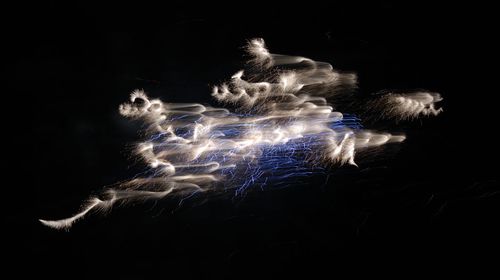 Close-up of illuminated lights against black background