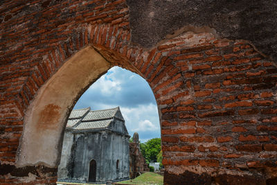 View of old building against cloudy sky