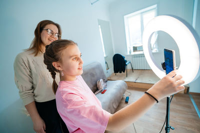 Mother and daughter record video use smartphone