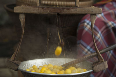 Silkworm cocoons boiling in container