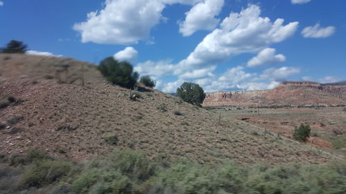 Scenic view of landscape against cloudy sky