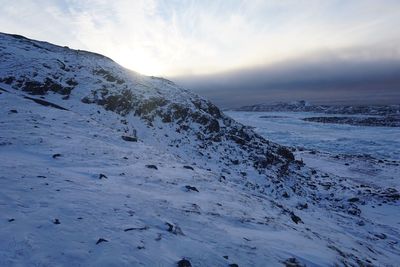 Scenic view of snow covered mountains against sky