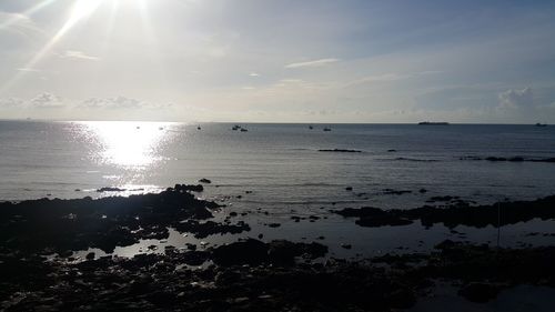 Scenic view of sea against sky at sunset