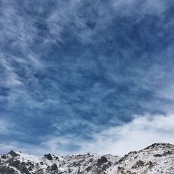 Scenic view of mountains against cloudy sky
