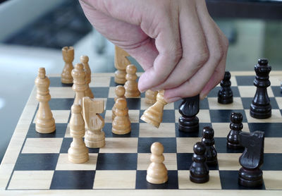 Close-up of man playing with chess