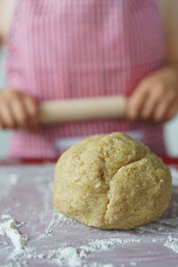 Young girl cooking bread.