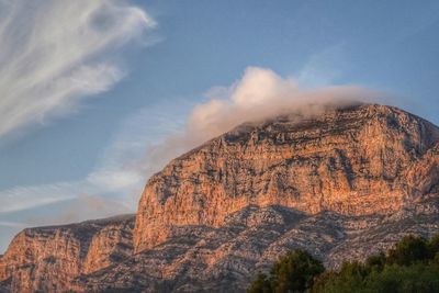 Rock formations on mountain against sky