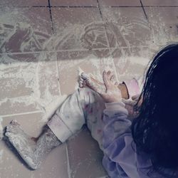 High angle view of woman standing against wall
