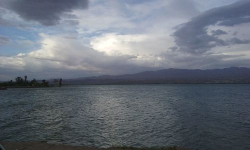 Scenic view of mountains against cloudy sky