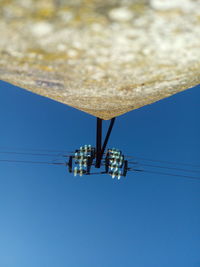 Low angle view of lamp post against blue sky