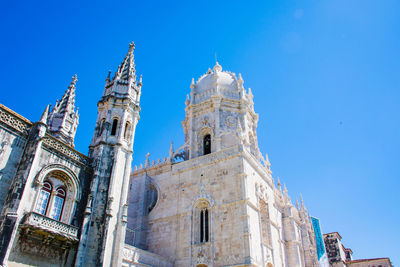 Low angle view of historic building against clear blue sky