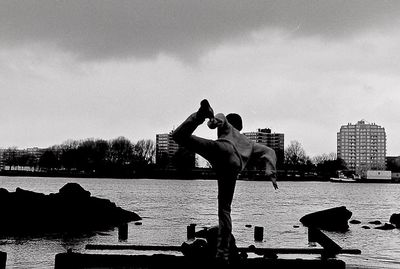 Men in front of city against sky