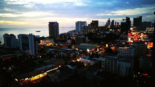 High angle view of illuminated buildings against sky during sunset