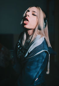 Young woman wearing hat standing at home