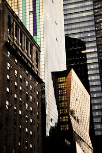 Low angle view of modern buildings in city against sky