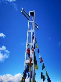 Low angle view of flags hanging against sky