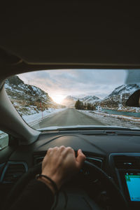 Close-up of hand on snow covered car