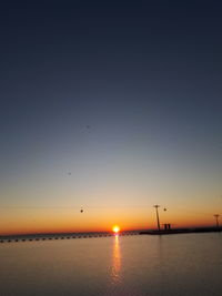 Scenic view of sea against clear sky during sunset