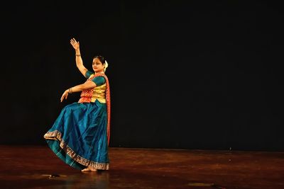 Woman performing kathak on stage