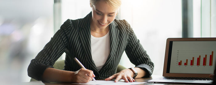 Midsection of woman using mobile phone