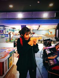 Young man photographing with camera in store