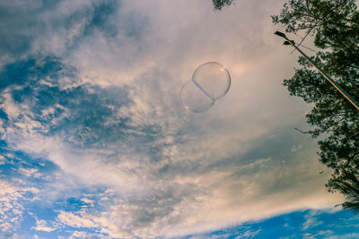 Low angle view of bubbles against sky