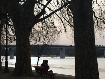 People sitting on tree trunk