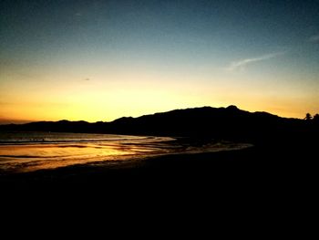 Scenic view of sea against clear sky during sunset