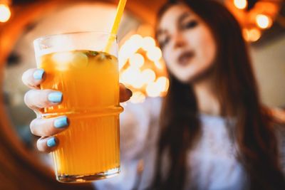 Close-up of a young woman drinking glass