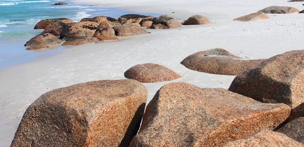 Rocks on beach against sky