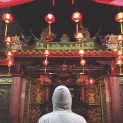 Low angle view of illuminated lights hanging in temple at night