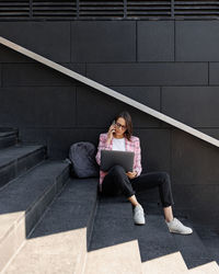 Rear view of woman sitting on chair