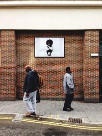 Full length of man walking on road in city