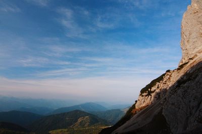 Scenic view of mountains against blue sky