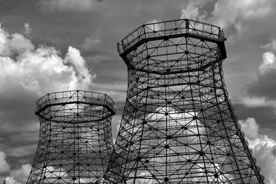 Low angle view of cooling tower structure against sky