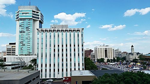 Buildings against cloudy sky