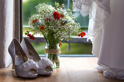 Close-up of footwear on wooden floor