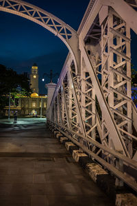 Illuminated bridge against sky at night