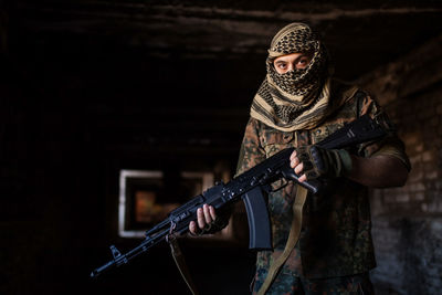 Portrait of serious middle eastern man with ak-47