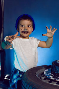 Baby boy eats his birthday cake in the form of a wheel in the studio